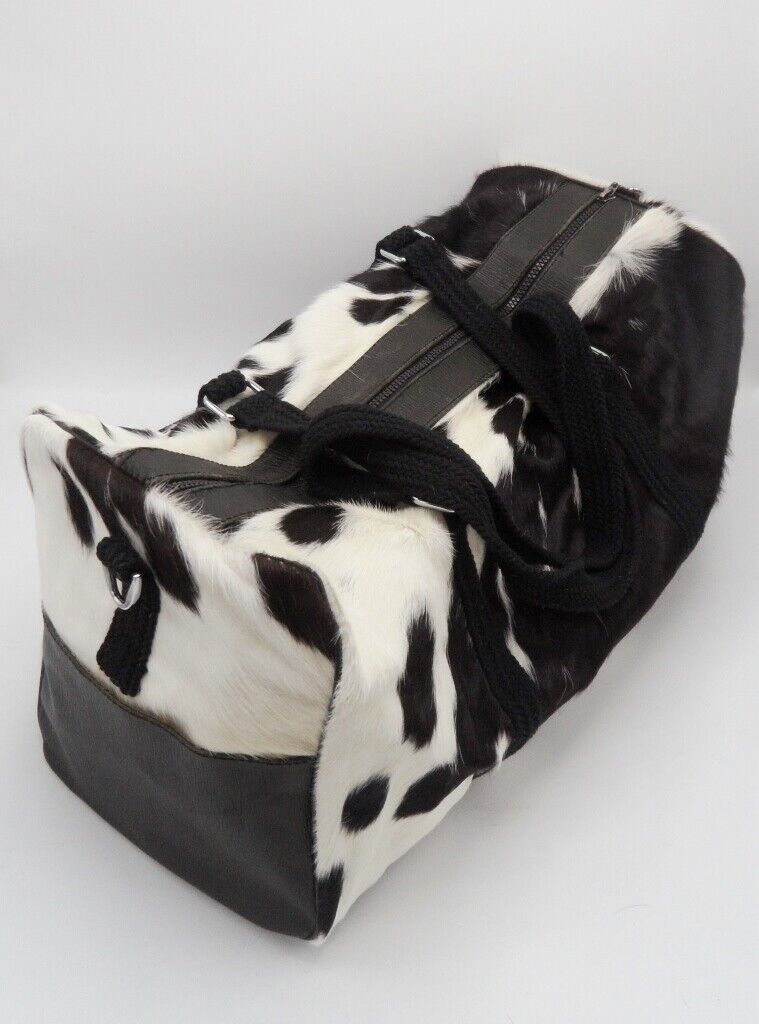 This airport cowhide luggage bag is made from durable black and white cowhide, so it can withstand the rigors of travel.