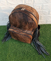 Not only does this cowhide backpack have plenty of space to store all your essentials, but its adjustable straps make it comfortable to carry around all day long.