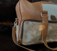 Conquer your fitness goals with this cow skin gym bag, designed to keep you organized on your journey to wellness.