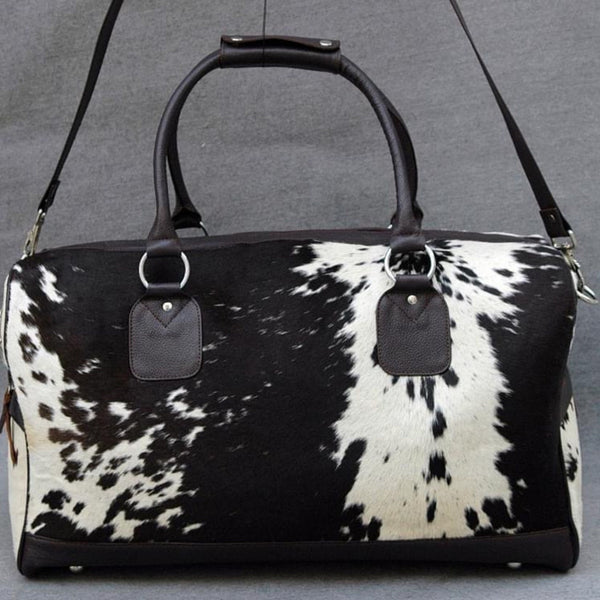 Looking for the perfect weekend or business trip bag? This black and white hair on cowhide duffel bag is stylish, lightweight and spacious - perfect for any occasion!