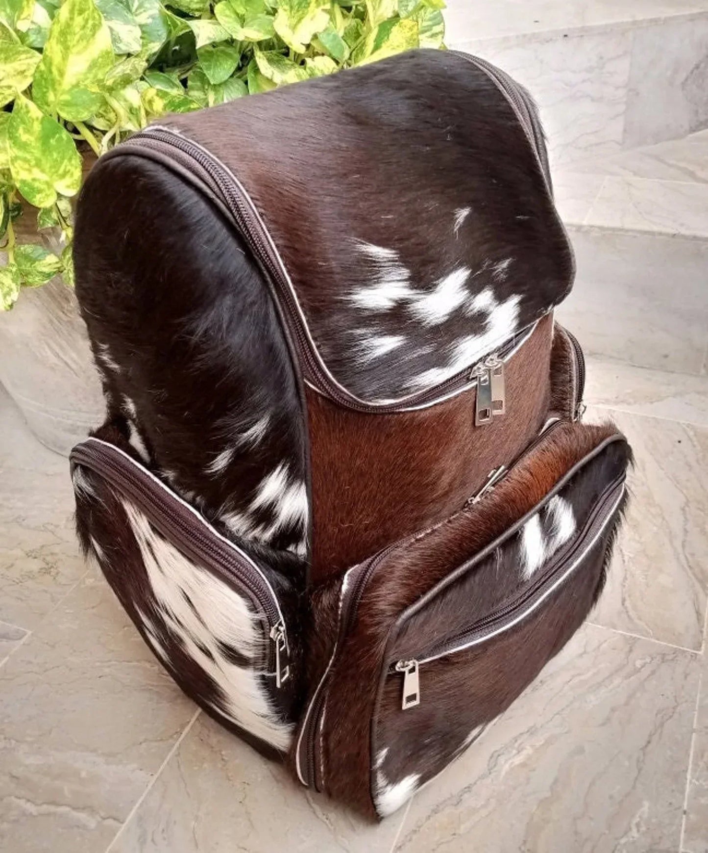 Brown white cowhide backpack with genuine hair-on hide