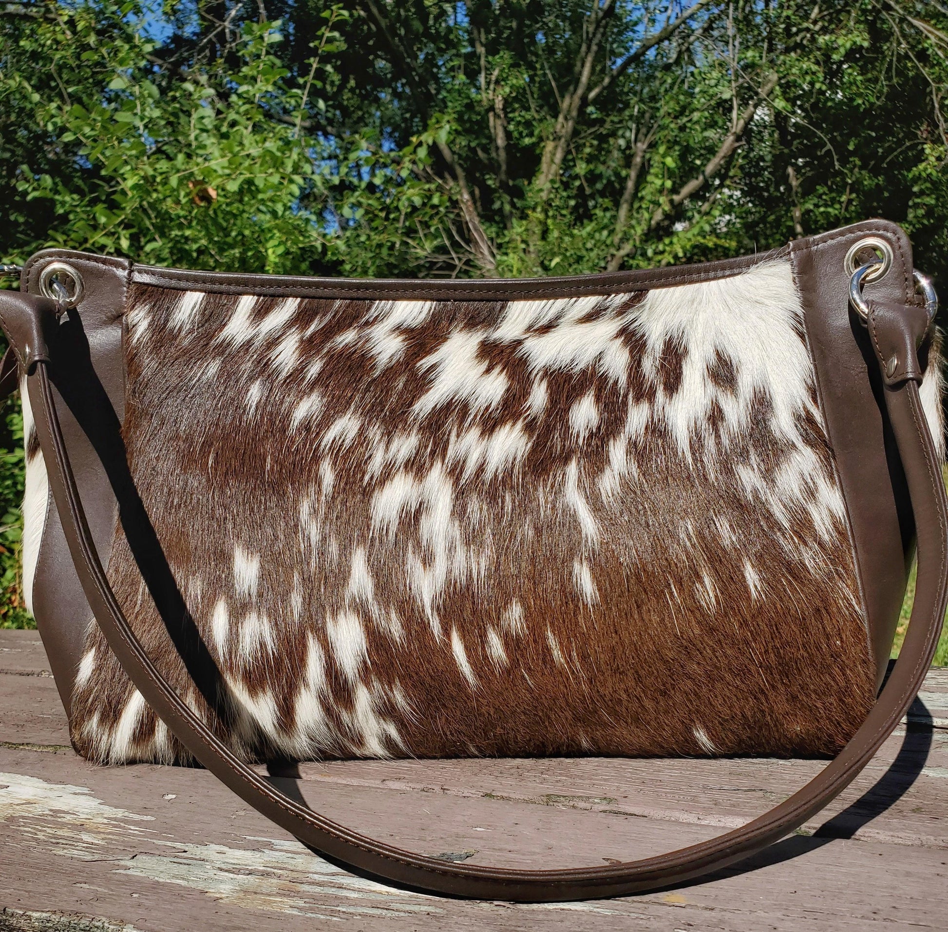 Calf hair purse with brown white hide shoulder strap