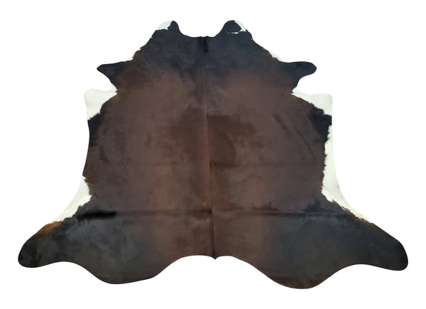 Exotic chocolate cowhide rug a mix of faded brown, black and white, giving your farmhouse living room a perfect western rodeo, free shipping USA.