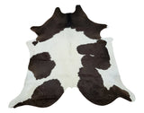 A country style living room can feature a brown white cowhide, it will impressive and chic.
