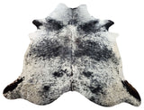 Searching for a cowhide rug this speckled black white is great for years to come, it's a statement piece and pulls the whole room together.
