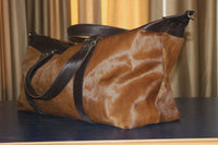 Embark on your next adventure with this cowhide travel bag, a blend of durability and style for the modern explorer.