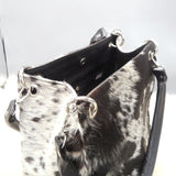 Finally, don't forget to accessorize! A cowhide shoulder bag is the perfect opportunity to show off your personality and black and white is stunning with a fringe.