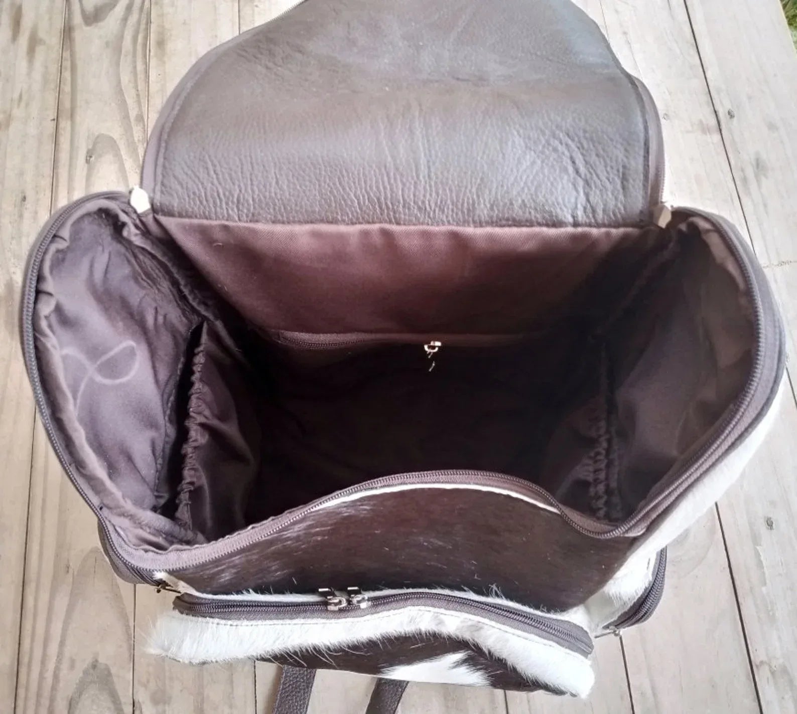 Cowhide leather backpack featuring natural speckled hair-on hide