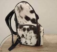 A unique dark brown and white etsy cowhide bag, it 3 side hair on cowhide, genuine plain leather on the back Inside Fully line Zip Compartment inside