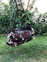 All our cowhide duffle bags in dark reddish brown and black are free shipping worldwide.