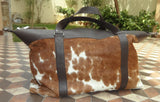 Step into the gym with confidence, carrying this chic cowhide gym bag, a fusion of style and utility.