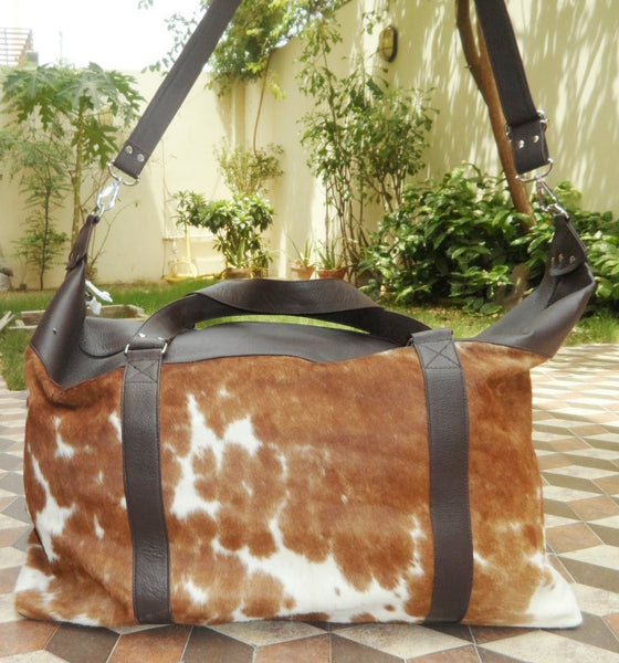 Elevate your travels with a cow skin overnight bag, blending timeless design with modern convenience.