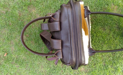 This cowhide shoulder bag is absolutely beautiful, buy it as a gift and you will love it, a lot of craftsmanship goes in these bag and free shipping.
