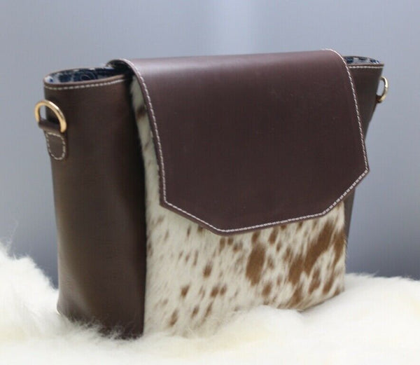 Featuring our new amazing speckled womens cowhide handbag with the touches of black, white and brown with premium leather and adjustable strap. 