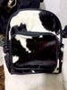 Detailed close-up of a cowhide backpack, highlighting soft fur texture, durable stitching, and quality craftsmanship.