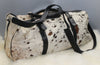 A cow fur travel or luggage bag made from real hair on hide and premium leather, perfect for everyday use, work, school and travel this bag is great for all kinds of season and take lots of beating.