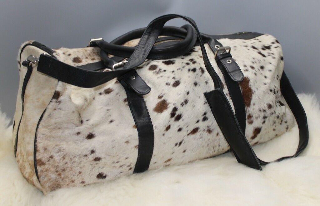 A cow fur travel or luggage bag made from real hair on hide and premium leather, perfect for everyday use, work, school and travel this bag is great for all kinds of season and take lots of beating.