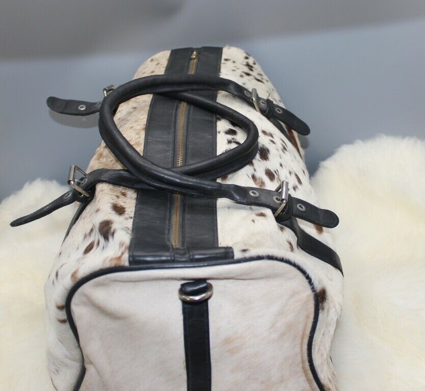 A beautiful speckled cowhide luggage bag great for weekend getaway it has inner pockets, metal zippers and detachable leather handle. 