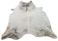 A brindle cowhide rug is a large, grey rug made from real cowhide. It's a natural product that will add a touch of luxury to any room.