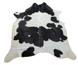 A natural cowhide rug in brilliant black white is perfect for any room or southern wedding.