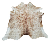 Speckled beige cowhide rug beautiful and brings our room together perfectly.