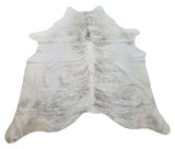 This large tan cowhide rug is unique and exotic, and will add a touch of luxury to any space.