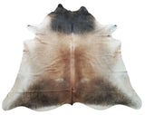 These gray-tan cowhide rugs are ideal for covering the bottom of a desk or table. They go well with the rest of the living room.