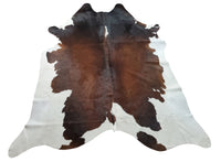 If you’re looking for a way to add some farmhouse flair to your living room, consider investing in a brown black cowhide rug. 
