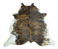 This cowhide rug is a beautiful tricolor mix of rustic brown, black, and white. It's natural, real, and exotic, and it was handpicked for its beauty. 