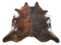 These cowhide rugs are very soft/pliable and not stiff at all which makes these great for upholstery, draped over furniture or even wall decor. Add this cowhide to your farmhouse living room.