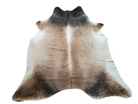 We simply never get tired of cappuccino cowhide rugs, the light and dark mixed pattern gives a country or farmhouse touch with no need of any backdrop.