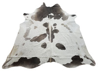  Grey white cowhide rug is great investment to hide the small problems of the living room, it can match easily with hardwood floors or entryway or even on the wall