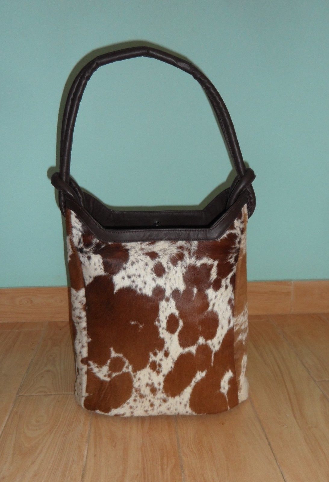 A cowhide bucket bag is a versatile and stylish option for any woman. They are roomy enough to carry all your essentials, but also look great with any outfit. 