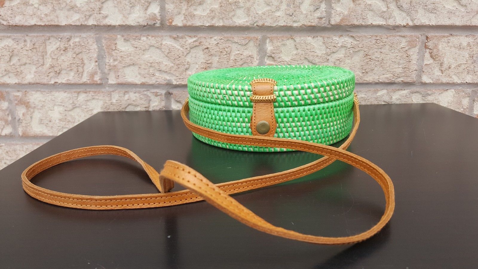 Handwoven rattan shoulder bag with a sleek design and sturdy strap.