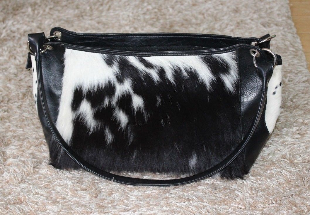 Natural cowhide gives this purse an amazing look and look you stunning. Front side cowhide with plain genuine leather on the other side.