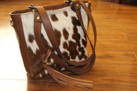 one of its kind brown and white cowhide shoulder bag
