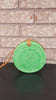 Handcrafted rattan crossbody bag with a circular design and secure clasp.
