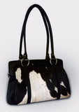 A cowhide satchel bag is woman's best friend, It is a trusty sidekick that holds all of her essentials, and more. A woman's purse should be stylish, but also functional.