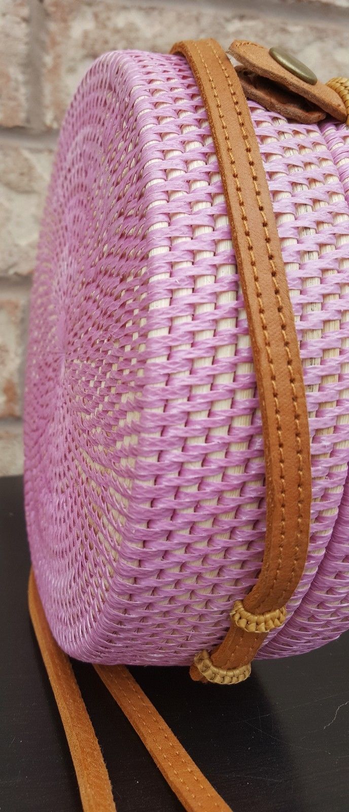 Handcrafted Bali rattan bag with intricate patterns and leather strap.