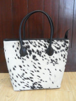 A black and white cowhide tote bag is the perfect accessory for any outfit. Whether you are going to the office or party this bag will make you look stylish. 