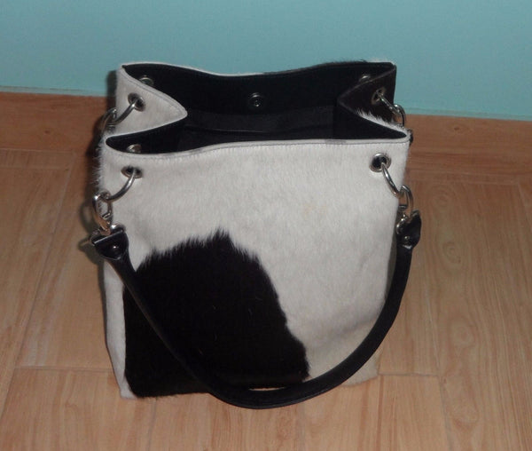 I bought this cowhide leather bag as a 3 year anniversary gift for my wife It came quickly and was exactly as described.